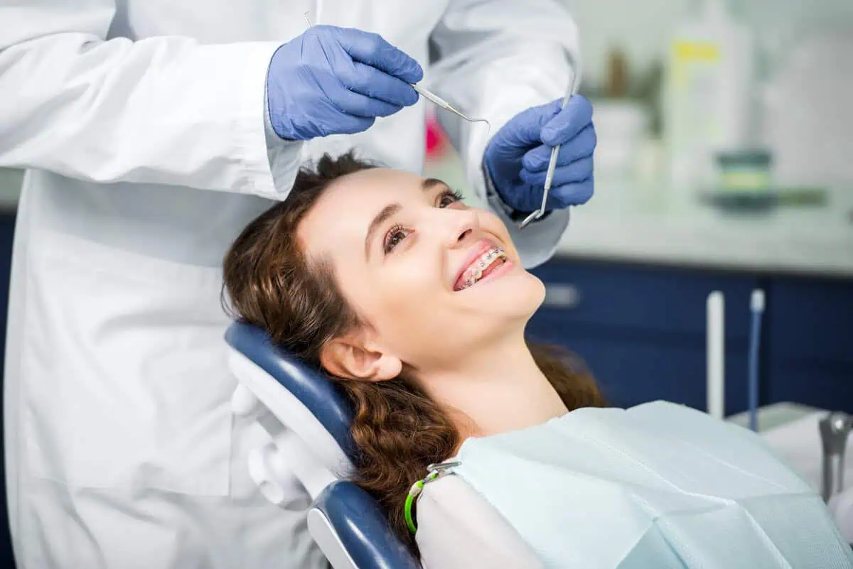 Cheerful woman with braces during an orthodontic exam